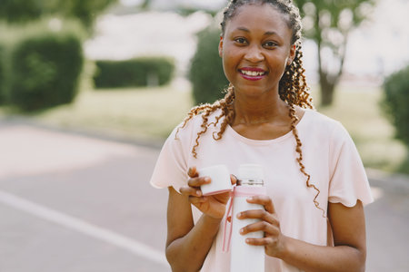 African american woman having workout in park in sportswear