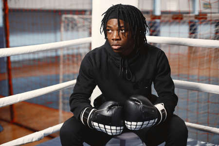 African male boxer in black gloves at the gymの写真素材