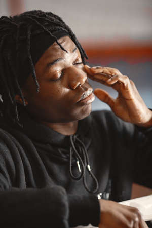 African male boxer in black gloves at the gymの写真素材