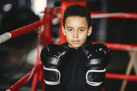Little boy in boxing gloves on ringの写真素材