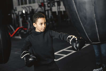 Little boy in boxing gloves on ringの写真素材