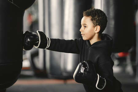 Little boy in boxing gloves on ringの写真素材