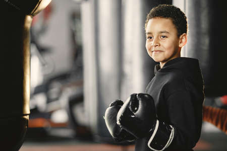 Little boy in boxing gloves on ringの写真素材