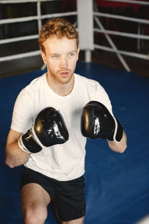 Male boxer in black gloves at the gymの写真素材