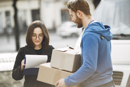 Man gives a parcel to a female client