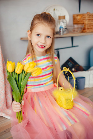 Cute little girl with a yellow flowers