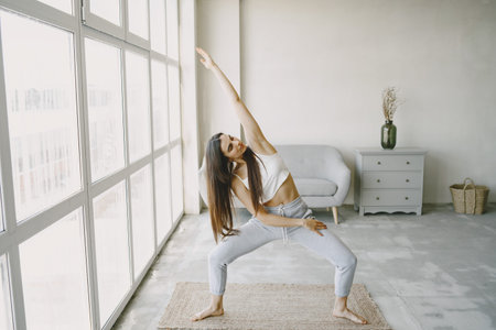 Girl doing yoga exercises at home in sportswear