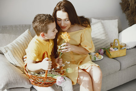 Mother and son inspect Easter eggs and put them in a basket