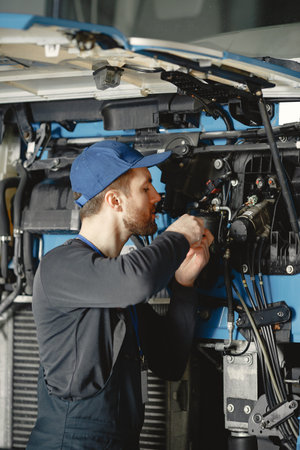 ar mechanic repairs blue car in garage with tools