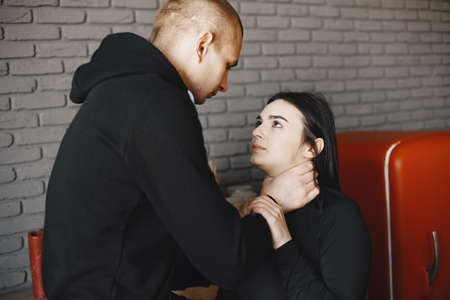 Husband beating and smothering wife during argumentの写真素材