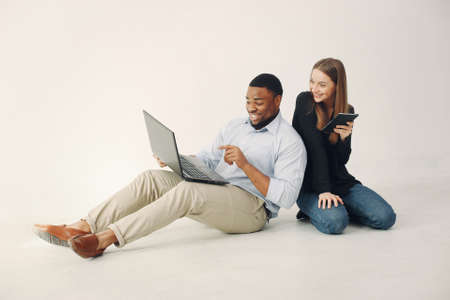 Young international couple working together and use the laptopの写真素材