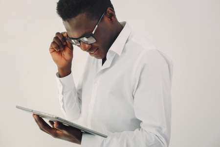 Handsome black man standing on a white backgroundの写真素材