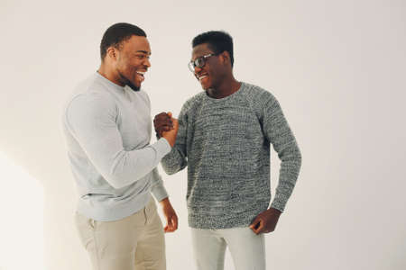 Handsome black men standing on a white backgroundの写真素材