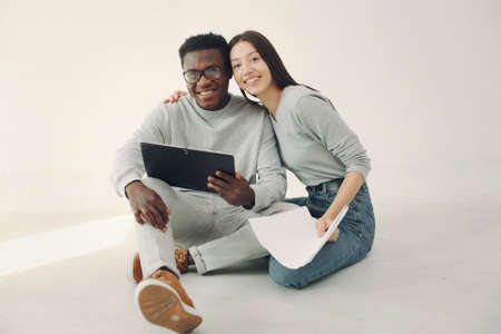 Young international couple working together and use tabletの写真素材