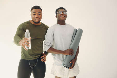 Sports men standing on a white backgroundの写真素材