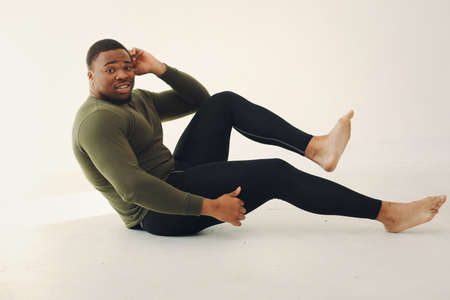Handsome black man doing yoga on a white backgroundの写真素材