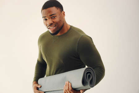 Handsome black man doing yoga on a white backgroundの写真素材
