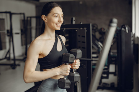 A beautiful girl is engaged in a gym