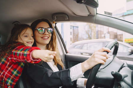 Cute mother and her daughter are traveling by carの写真素材
