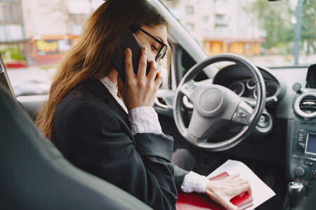Businesswoman sitting inside a carの写真素材