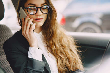 Businesswoman sitting inside a carの写真素材