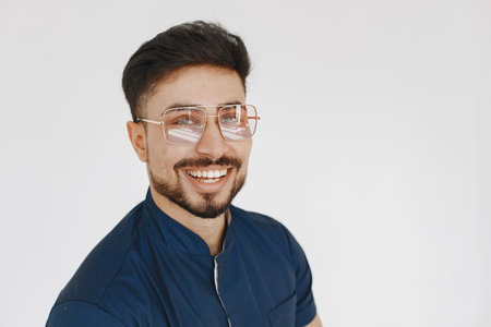 A portrait of a medical doctor posing against white background