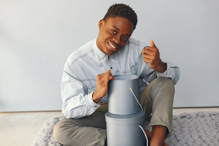 Handsome black man sitting on a white background