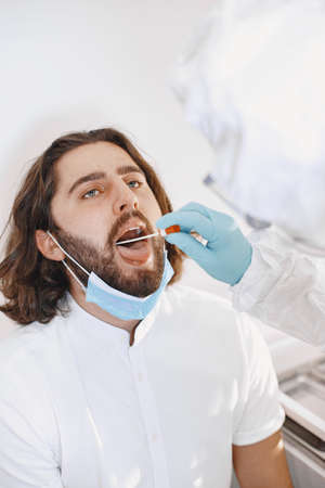 Medical worker taking a swab for virusの写真素材