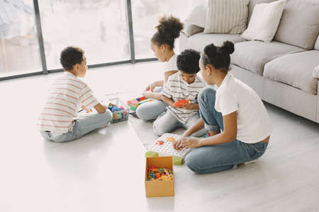 Children play with a colored constructor on floorの写真素材