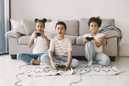 Children play in video games at home on floorの写真素材
