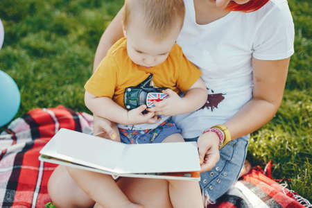 Mother with son playing in a summer parkの写真素材