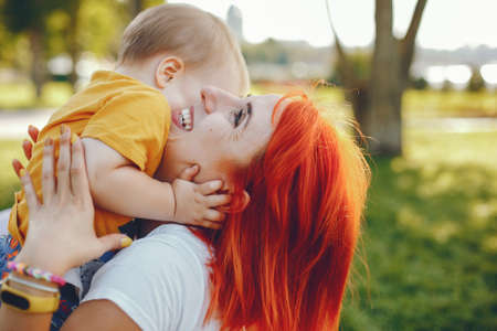 Mother with son playing in a summer parkの写真素材