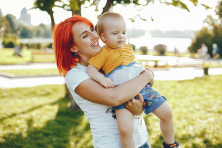 Mother with son playing in a summer parkの写真素材