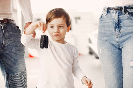 Family with little son in a car salonの写真素材