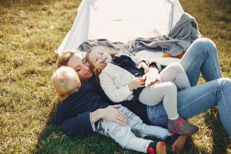 Mother with children playing in a summer parkの写真素材