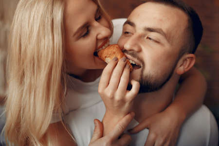 Couple sitting on a bed in a roomの写真素材