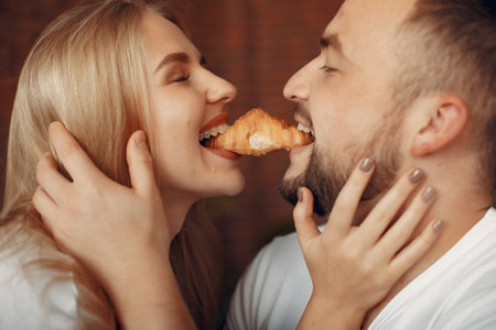 Couple sitting on a bed in a roomの写真素材