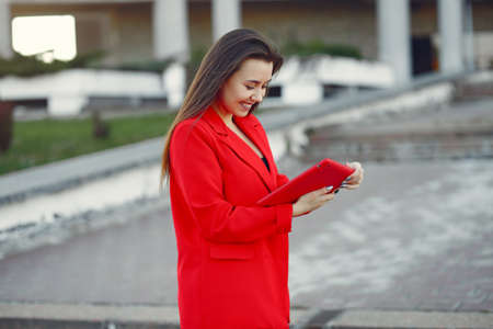 Woman in red jacket use a tabletの写真素材