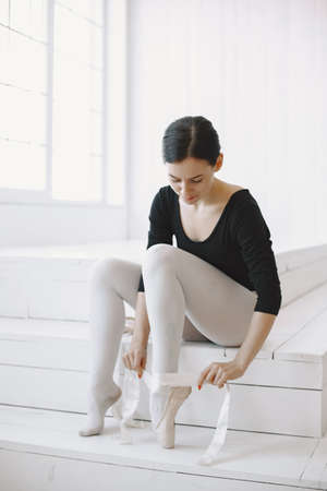 Ballerina posing in front of white backgroundの写真素材