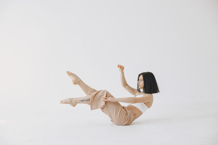 Beautiful young woman dancing in studioの写真素材