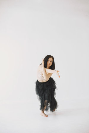 Beautiful young woman dancing in studio