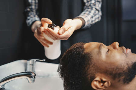 Young African-american man visiting barbershopの写真素材