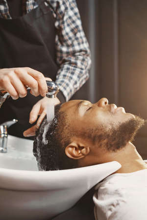 Young African-american man visiting barbershopの写真素材