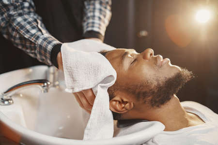 Young African-american man visiting barbershopの写真素材