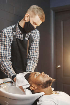 Young African-american man visiting barbershopの写真素材