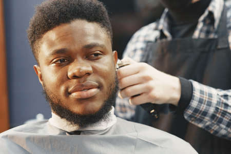 Young African-american man visiting barbershopの写真素材