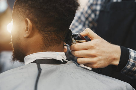 Young African-american man visiting barbershop