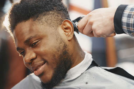 Young African-american man visiting barbershopの写真素材