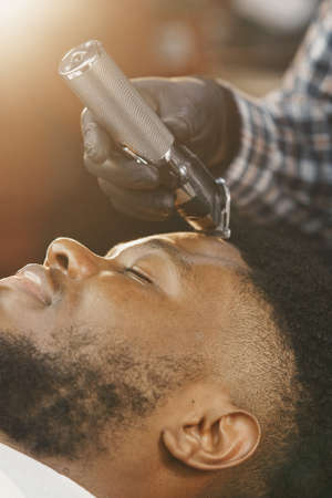 Young African-american man visiting barbershopの写真素材