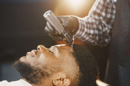Young African-american man visiting barbershopの写真素材